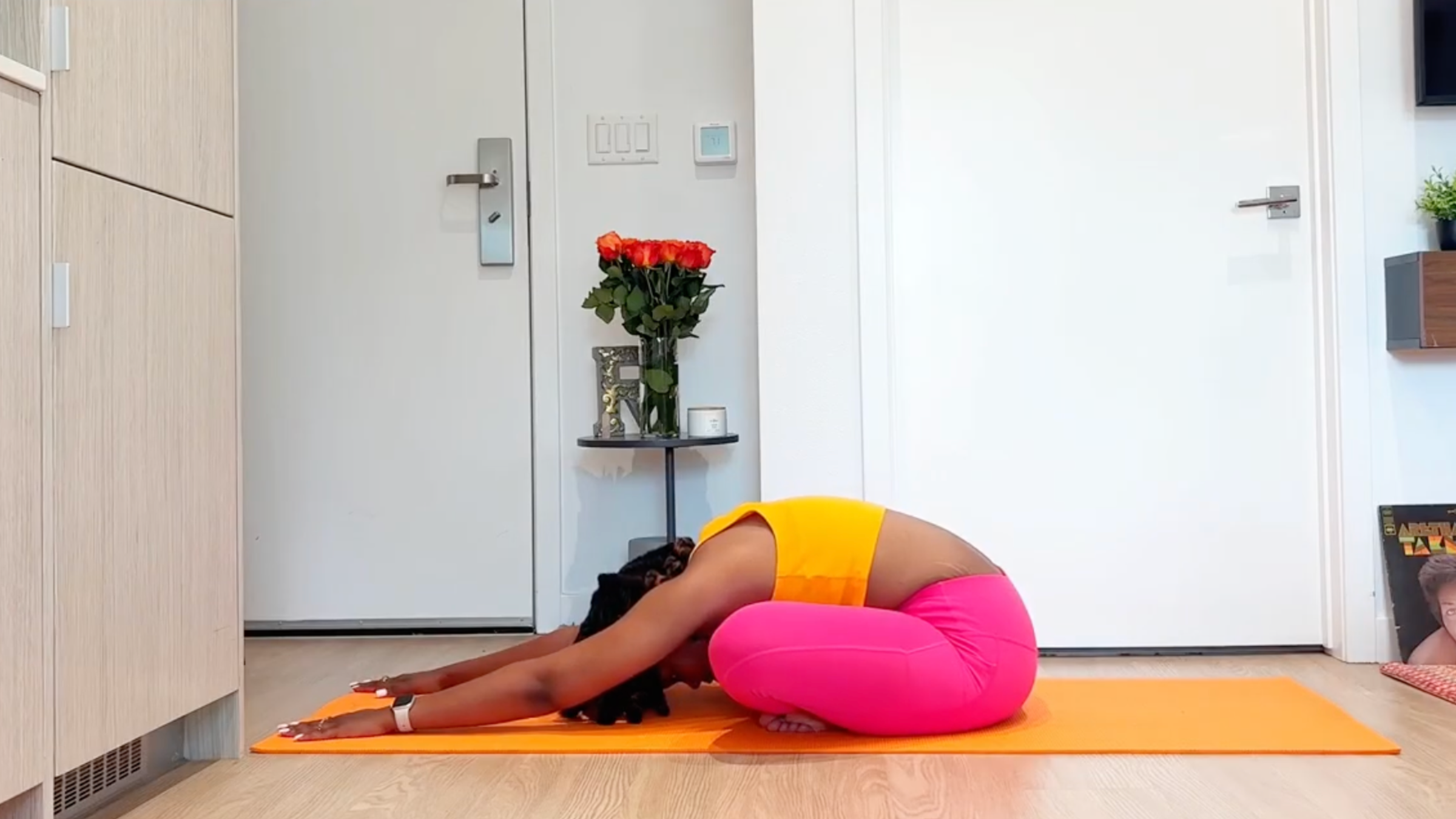 Yoga teacher practicing Cross-Legged Forward Fold